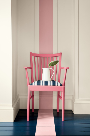 Dark pink (Carmine) chair with a dusky pink stripe painted from the wall down to the navy blue panelled floor.