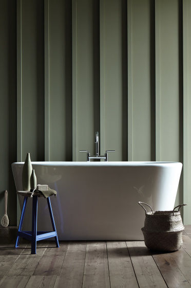 Bathroom featuring 'Sage Green' paneled walls, a white freestanding bathtub and a Purple-Blue stool in 'Mambo'