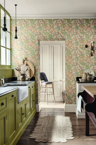 Kitchen with bright green cabinets (Citrine) and a paisley wallpaper (Pomegranate - Bazaar) with a wooden floor and rug.