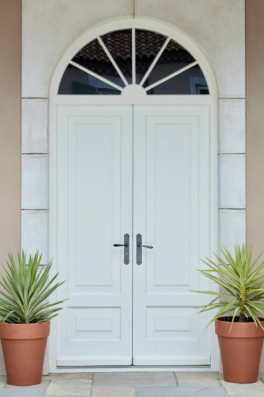 Front door entrance in bright white (Shirting) with matching surround and contrasting neutral back wall and two plant pots.