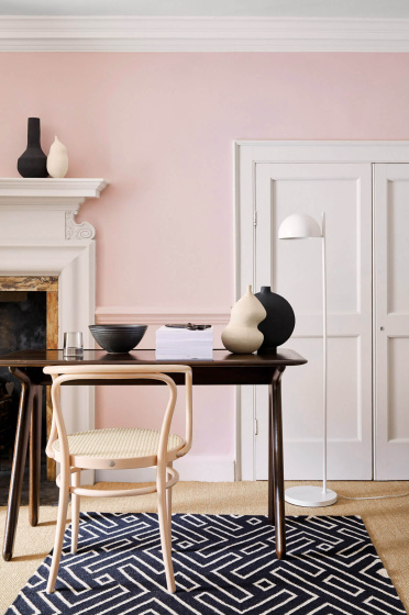 Home office with pale pink (Pink Slip) walls and contrasting neutral woodwork alongside a fireplace, wooden desk and chair.