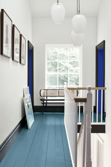 Hallway with an Air Force Blue painted floor, contrasting white (Shallows) walls and a window at the end of the corridor.