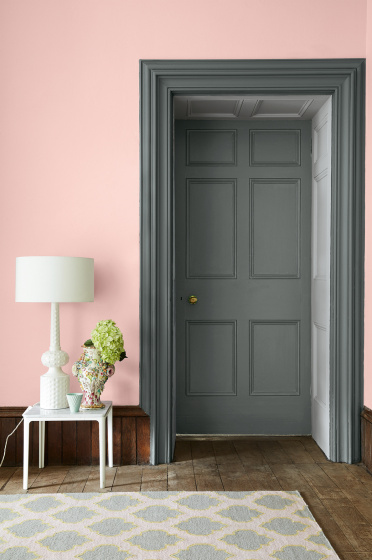 Doorway entrance with a grey green (Livid) painted door and doorframe with a contrasting pale pink (Confetti) wall.