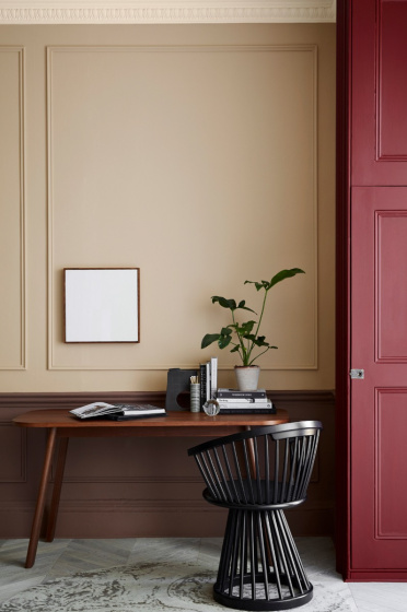Warm neutral (Castell Pink) home study area with a red (Arras) door next to a wooden desk and chair.  