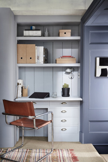 Home office space painted in cool neutral 'Obscura' and dark blue 'Juniper Ash', with a desk and office chair. 