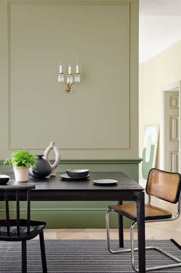 Dining space in neutral green 'Book Room Green' with a 'Sage Green' lower wall, and black dining room table and chairs.