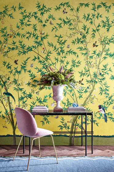Home study with a bright yellow floral and bird wallpaper (Belton Scenic - Sunbeam) with a desk and chair placed in front.