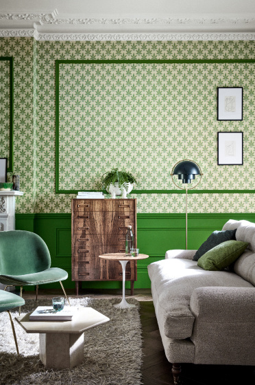 Living room featuring leaf wallpaper (Clutterbuck - Lodge) alongside green panelling and ceiling with coving.