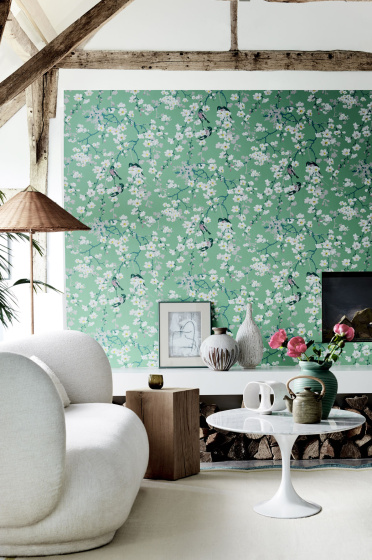 Living area with green printed floral and bird wallpaper (Massingberd Blossom - Verditer), cream sofa and ceiling beams.