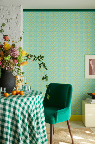Morning room featuring vibrant green small print floral wallpaper (Ditsy Block - Green Verditer) with a table,  green chair and vase of flowers.