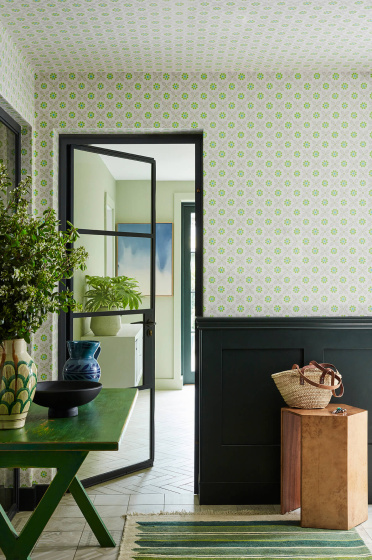 Hallway featuring green and grey small print floral wallpaper (Ditsy Block - Phthalo) with contrasting green woodwork and a stripy rug.